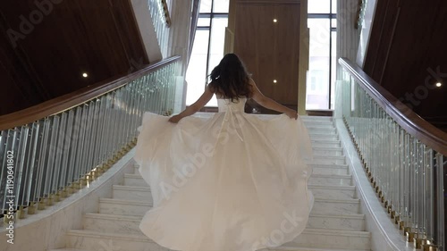 Elegant Bride Ascending the Stairs in a Stunning Wedding Dress
