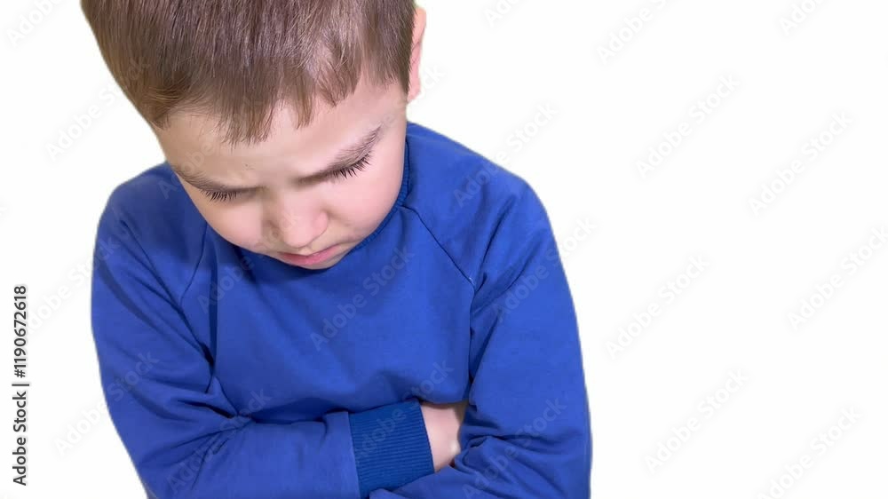The face of an offended boy with a look from under his brow. resentment, grief. Unhappy childhood. Child abuse. The face of an offended boy with a look from under his brow. resentment, grief. Unhappy childhood. Child abuse.