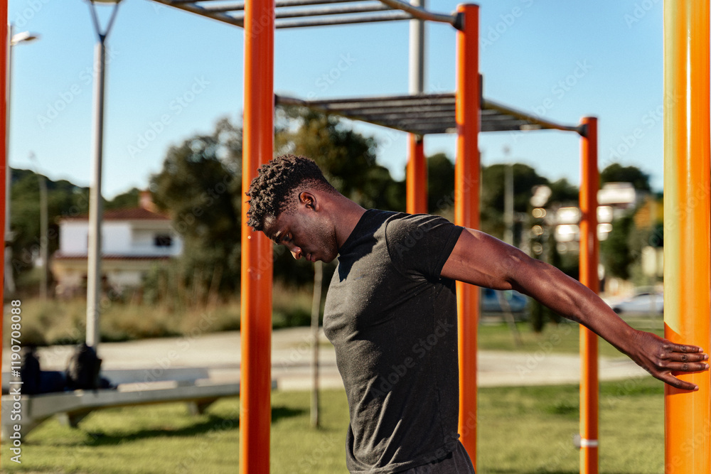 Obraz premium Athlete Stretching Before Workout in Urban Fitness Zone
