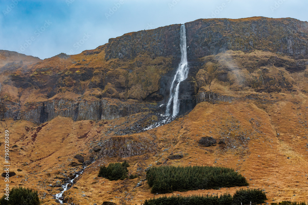 The high waterfall Bjarnarfoss in the autumn landscape in the west of Iceland