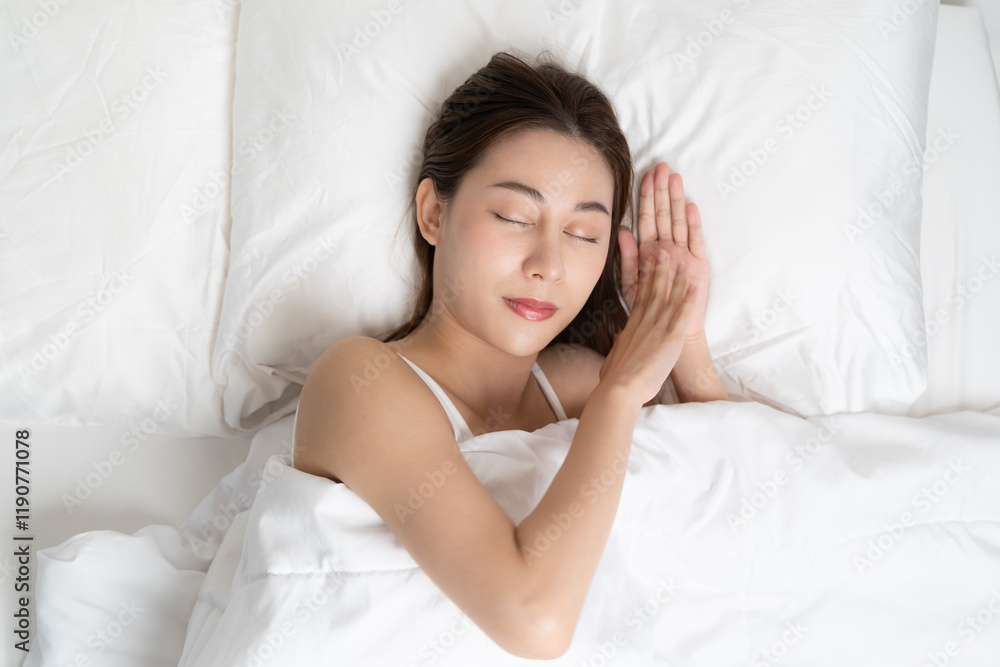 Top view of beautiful woman sleeping well on white soft pillow on the bed at home. Top view of beautiful woman sleeping well on white soft pillow on the bed at home.