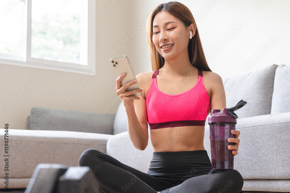 young sporty girl drink protein shake to build muscle after workout at home. young sporty girl drink protein shake to build muscle after workout at home.