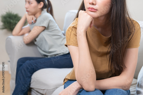 Photos lgbt couple have a quarrel sitting separated on the sofa