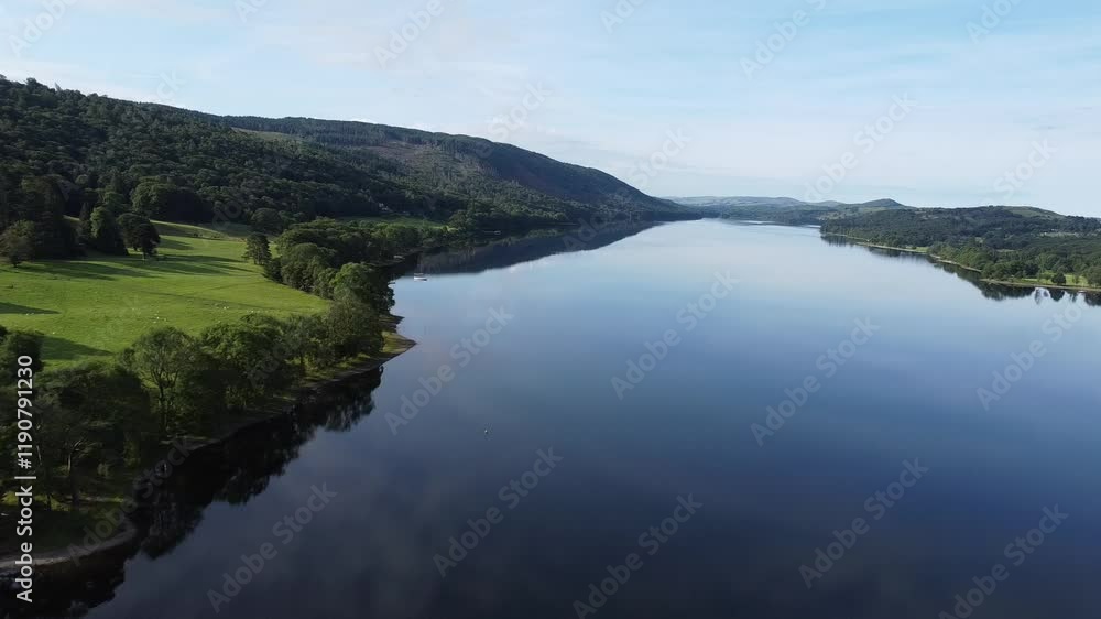 Drone scene of Lake Coniston reflecting its greenery surroundings and blue sky in Lake District Drone scene of Lake Coniston reflecting its greenery surroundings and blue sky in Lake District