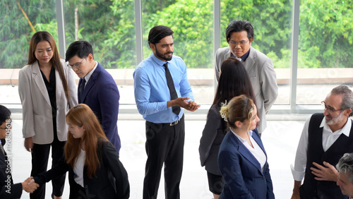 group of diverse business team building standing and talking and introduce yourself after meeting in seminar conference . Multicultural business people discussing or having a conversation