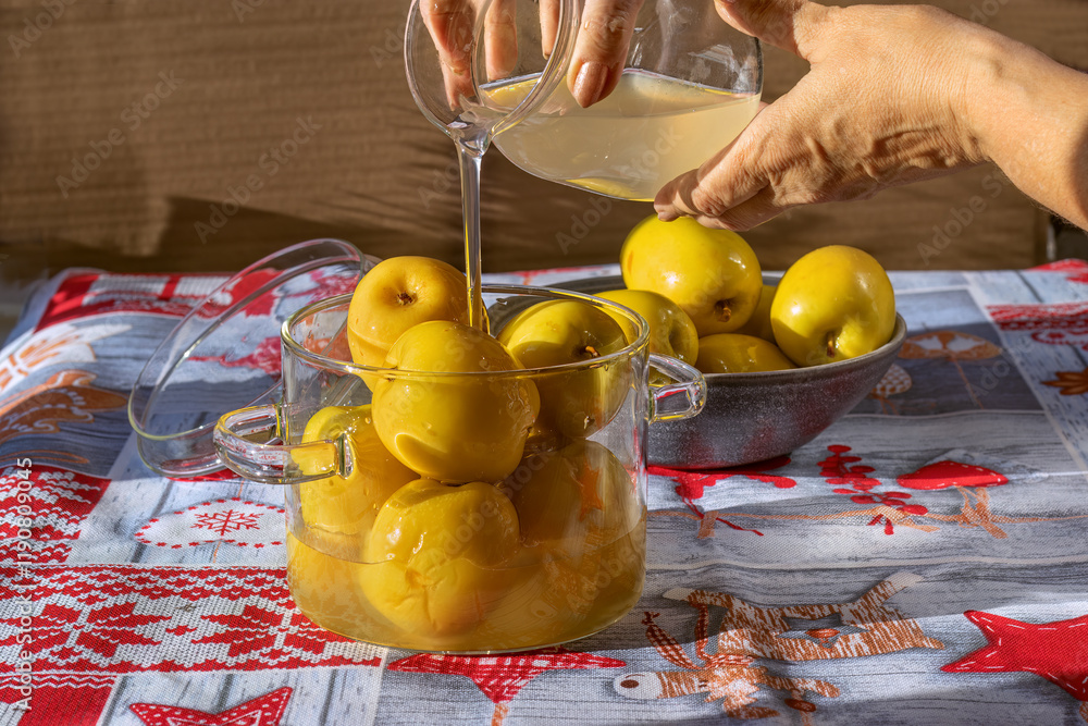 Wall Mural Fermented apples. Pouring brine over apples.