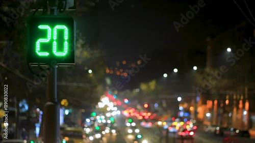 Wallpaper Mural Traffic light with green countdown timer against the backdrop of a night city. Blurred moving car lights and street lighting create a dynamic atmosphere Torontodigital.ca