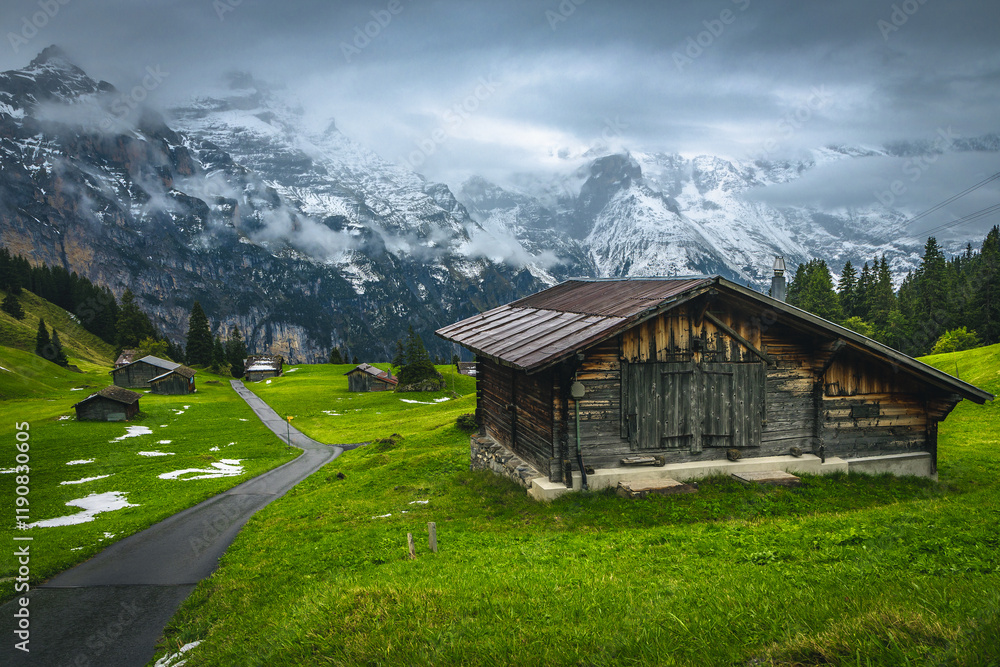 Wooden huts and misty snowy mountains in Switzerland
