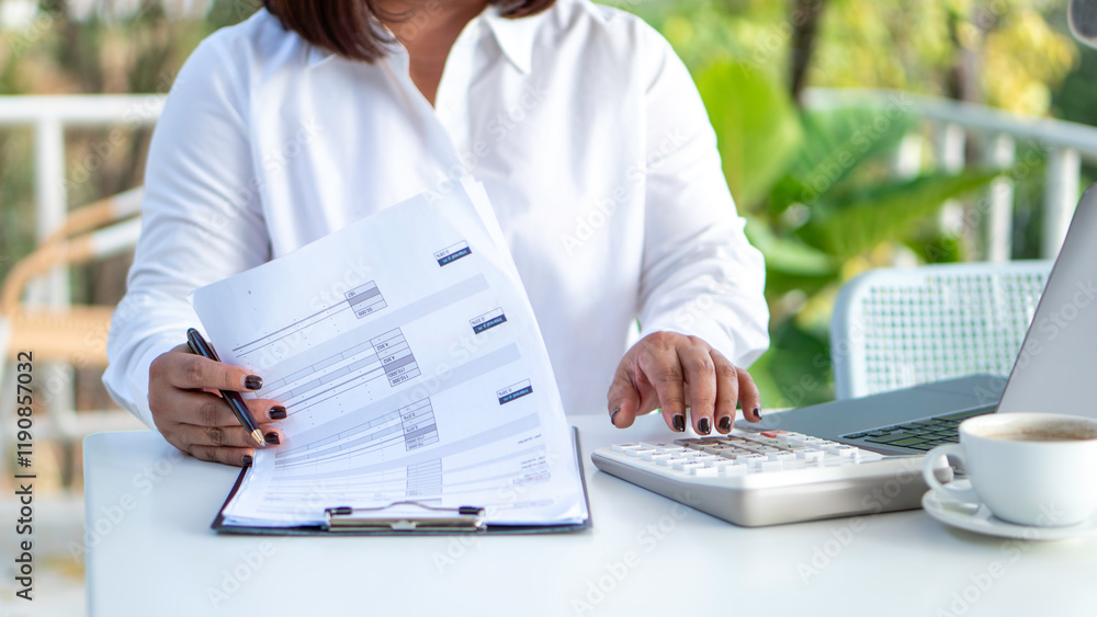 businesswoman check company finances and earnings and budget. Business woman calculating expenses, managing budget, papers, loan documents, invoices. count taxes rental tenancy sum to pay online.