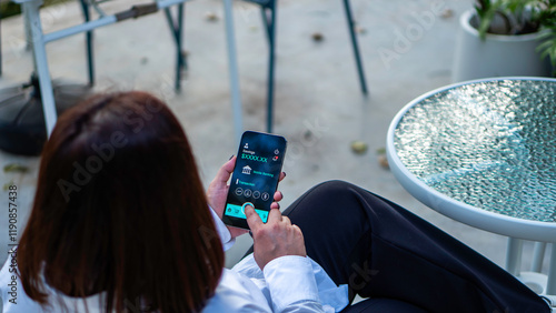 Obraz na płótnie online shopping and payment via mobile banking apps. a woman accessing a mobile banking app on her smartphone, Internet bank, money transaction, fintech, Digital banking network, internet payment w salonie