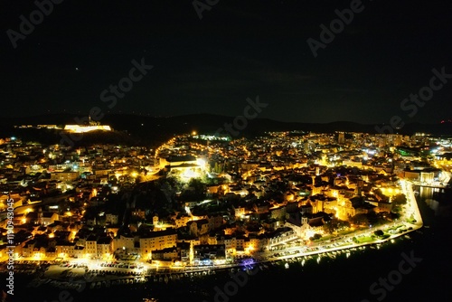 Sibenik historical city on the Adriatic coast of Croatia aerial panorama night view of old town square and town hall tower with shining lights,Europe known as a gateway to the Kornati Islands photo