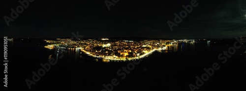 Sibenik historical city on the Adriatic coast of Croatia aerial panorama night view of old town square and town hall tower with shining lights,Europe known as a gateway to the Kornati Islands photo