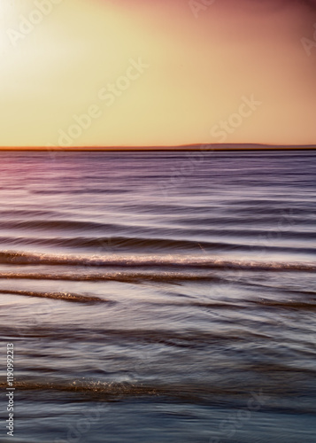 Blurred effect sunset beach scene with ocean