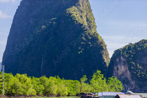 A distant natural background of a large mountain in the middle of the sea, Phang Nga Bay, Thailand, from a major viewpoint where tourists come to watch the sunrise in the morning. photo