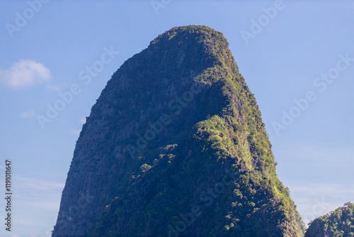 A distant natural background of a large mountain in the middle of the sea, Phang Nga Bay, Thailand, from a major viewpoint where tourists come to watch the sunrise in the morning. photo