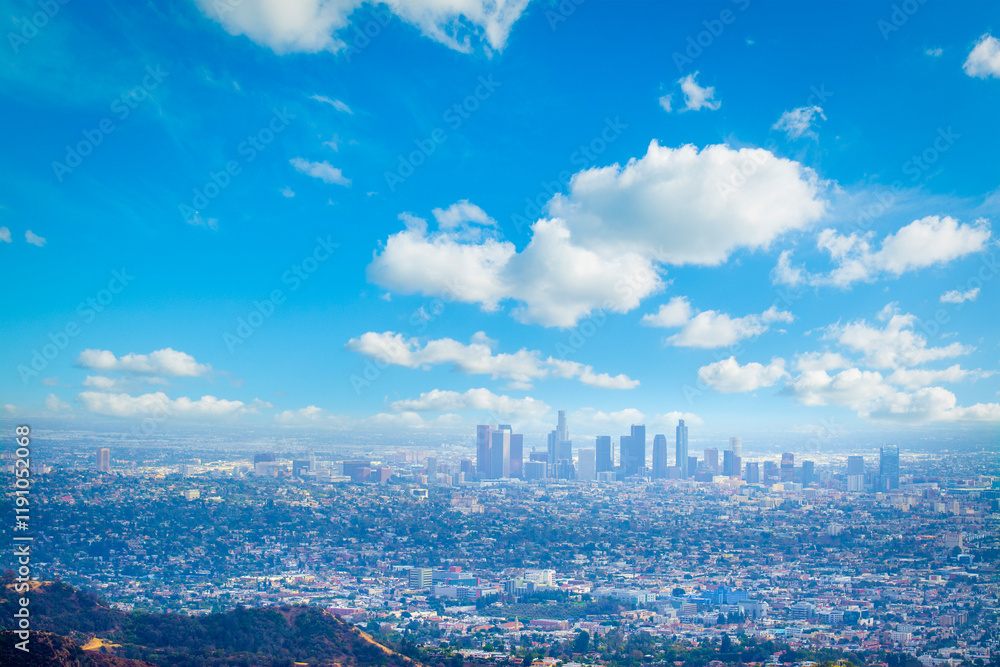 Los Angeles skyline under a blue sky with clouds