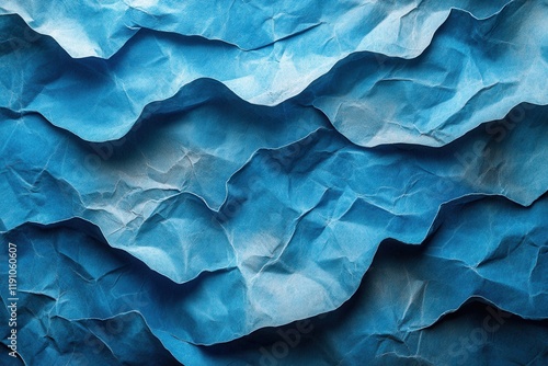 Wallpaper Mural Crumpled blue paper forming textured waves under soft light in a creative workspace environment Torontodigital.ca