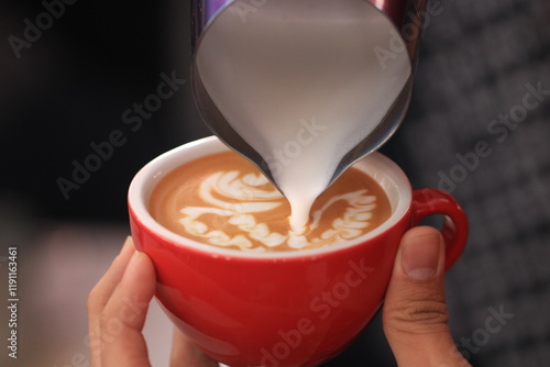 Konstfotografi Milk pours into cup creating coffee art by barista.