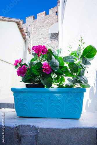 Blauer Blumentopf  mit Geranien in der Griechischen Altstadt von Kavala