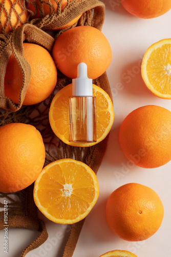 Oil dropper bottle resting on an orange slice, styled with a net bag and citrus. Perfect for concepts of health, beauty, and nature