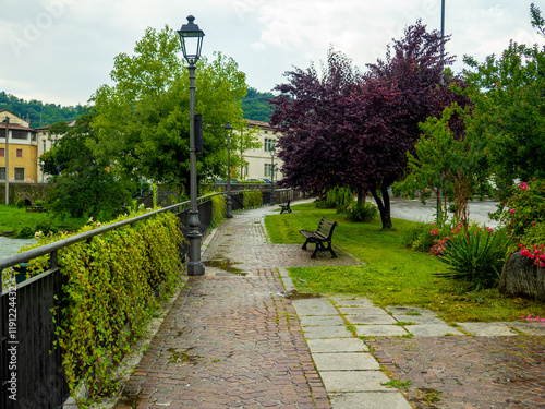 Cityscape with river and walkway in village of Sabbio Chiese, Brescia, Italy. Beautiful mountain village in Sabbia Valley in northern Italy. A medieval town in Lombardy. photo