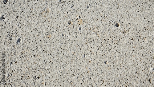Texture of volcanic pumice stone with countless air pockets and jagged edges in pale gray and brown tones