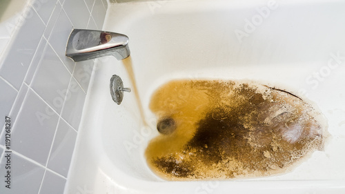 Discolored water draining from bathtub after use