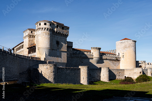 Majestic Cuéllar Castle: A Medieval Fortress Standing Proud Against a Blue Sky.