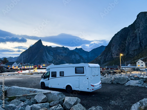 Motorhomes at sunrise with the stunning reflection of mountains and scenic landscape in Reine, Lofoten Islands, Norway. photo