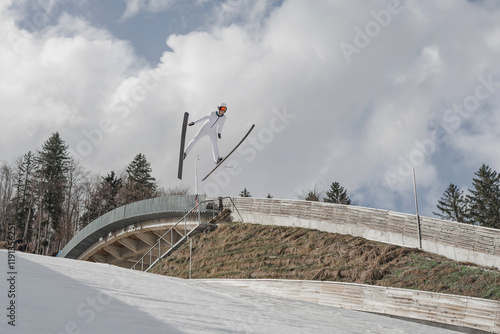 Slika na platnu Professional male athlete performing ski jumping, flying through the air during training