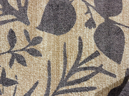 Random texture of custom bespoke carpet rug design, in flower, leaves, and trees branches pattern. Green, pink, and beige color. Luxurious seamless background carpet texture. photo