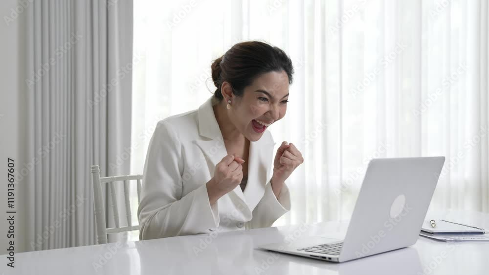 Young asian businesswoman celebrate a big sales or successful business campaign, triumphant smile and excited facial express while sitting on her desk with laptop. Vivancy office worker celebrating Young asian businesswoman celebrate a big sales or successful business campaign, triumphant smile and excited facial express while sitting on her desk with laptop. Vivancy office worker celebrating