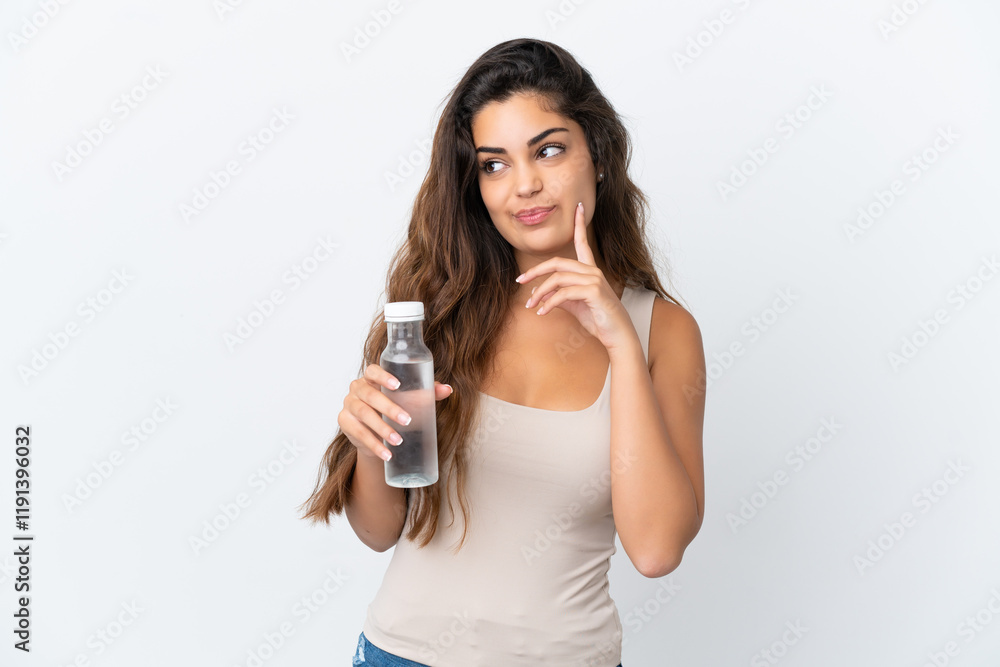 Young caucasian woman with a bottle of water isolated on white background thinking an idea while looking up Young caucasian woman with a bottle of water isolated on white background thinking an idea while looking up