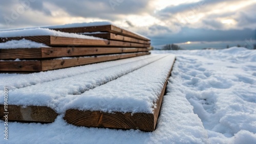 Wallpaper Mural Medium closeup image highlighting a pile of wooden boards covered in a thick layer of fluffy snow with traces of footprints leading to the materials suggesting recent use. Torontodigital.ca