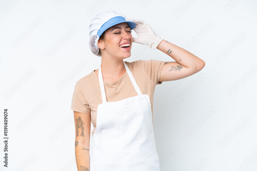 Fishmonger wearing an apron and holding a raw fish isolated on white background smiling a lot Fishmonger wearing an apron and holding a raw fish isolated on white background smiling a lot