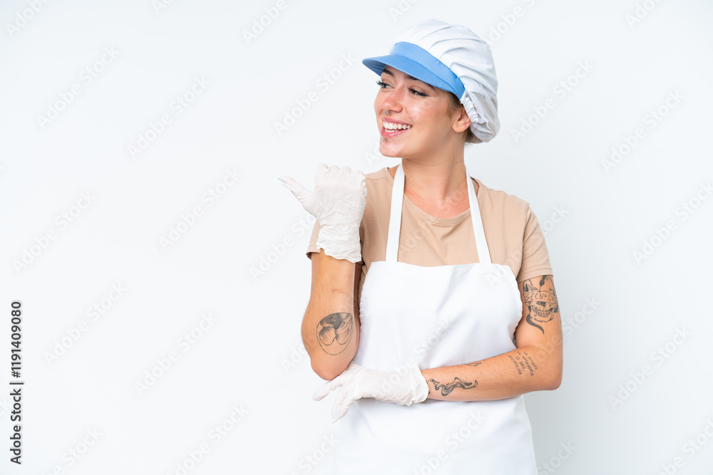 Fishmonger wearing an apron and holding a raw fish isolated on white background pointing to the side to present a product Fishmonger wearing an apron and holding a raw fish isolated on white background pointing to the side to present a product