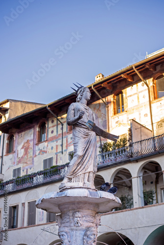 Statue of italian Madonna Verona with old buildings photo