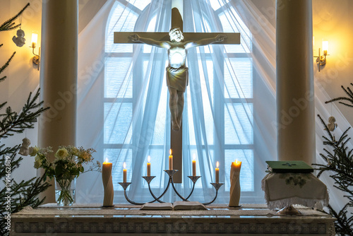 Crucifix and Candles on Church Altar. Sacred Altar with Crucifix and Candlelight. photo