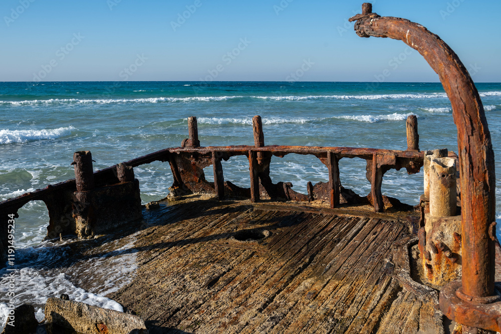 Fototapeta premium Close up of and abandoned rusty shipwreck at HaBonim Beach Nature Reserve on the Mediterranean Sea in Israel.