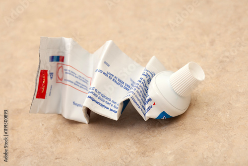 completely squeezed tube of toothpaste as a symbol of exhaustion of resources, energy, or effort, indicating that everything has been used up .