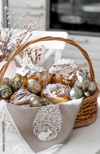 Banner for Orthodox Easter. Easter eggs with gold, Easter cakes and gingerbread in the shape of the letters XB in a woven basket made of vines. photo