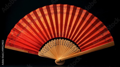 Elegant black fan with intricate golden designs and wooden handle displayed a...