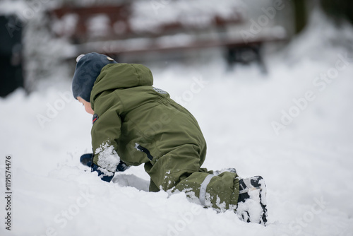 Wallpaper Mural Small toddler boy playing in winter snow having great time of excersise in fresh air Torontodigital.ca