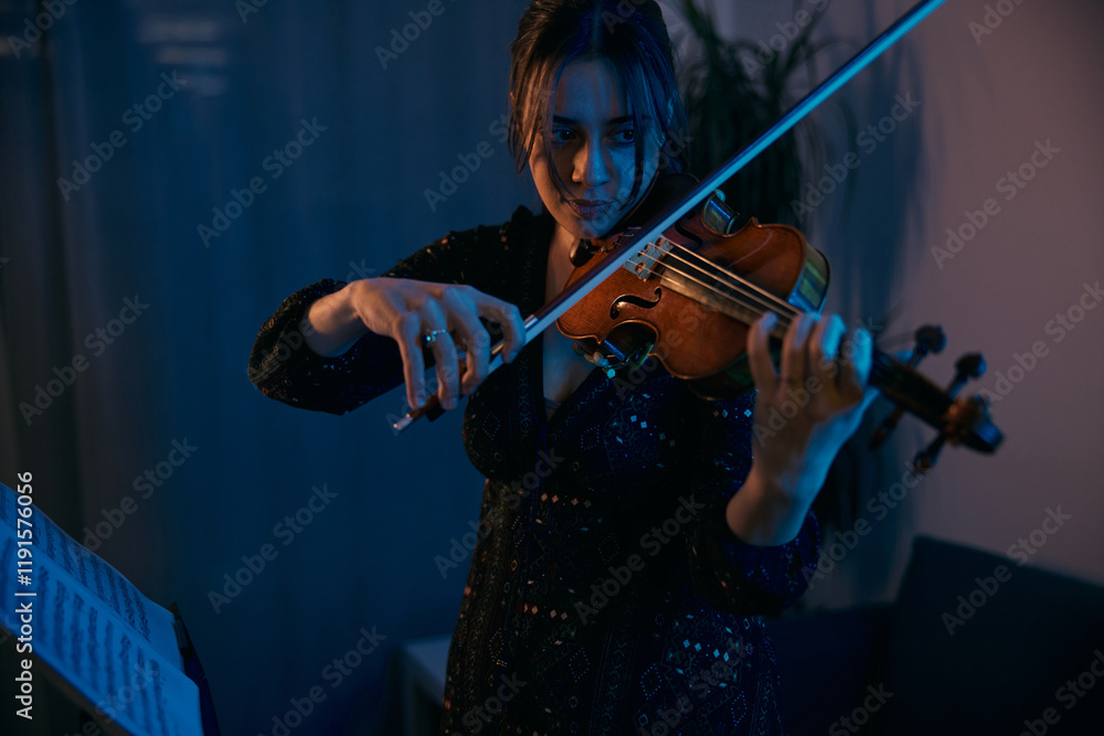 Fototapeta premium Female Violinist is Preparing for a Concert