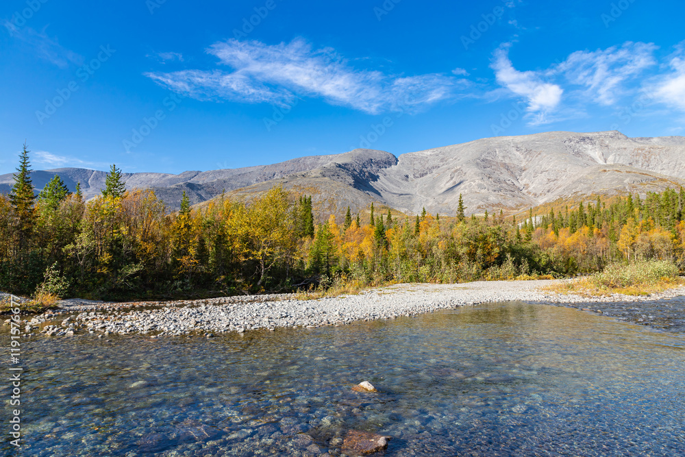 Scenic view of Khibiny mountains with North Chorrgor pass, forest and cold crystal water river Kuniyok. Kola Peninsula, Murmansk region, Russia.