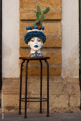 Moor's head/ Testa di Moro with woman's face, Sicilian artisan ceramic, Caltagirone artistic ceramic in white and turquoise, Sicily, close-up, isolated.