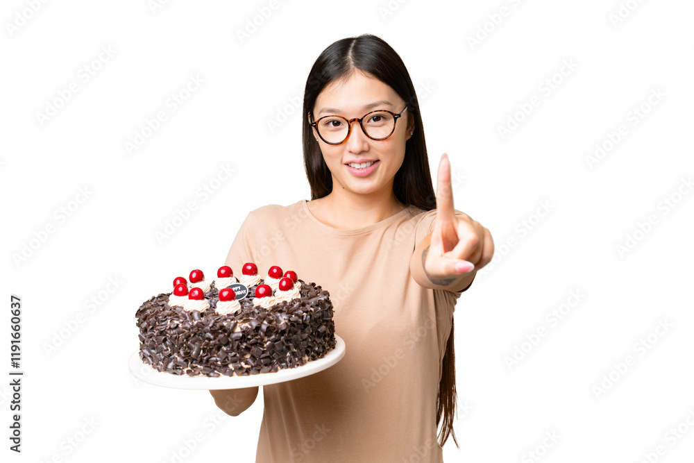Young Asian woman holding birthday cake over isolated chroma key background showing and lifting a finger Young Asian woman holding birthday cake over isolated chroma key background showing and lifting a finger