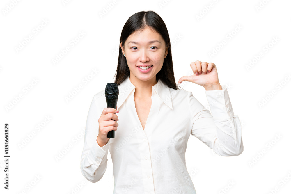 Singer picking up a microphone over isolated chroma key background proud and self-satisfied Singer picking up a microphone over isolated chroma key background proud and self-satisfied