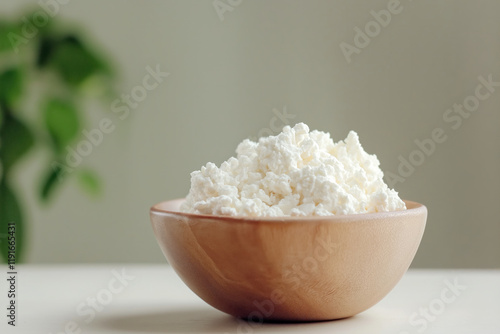 Fresh cottage cheese in wooden bowl. photo