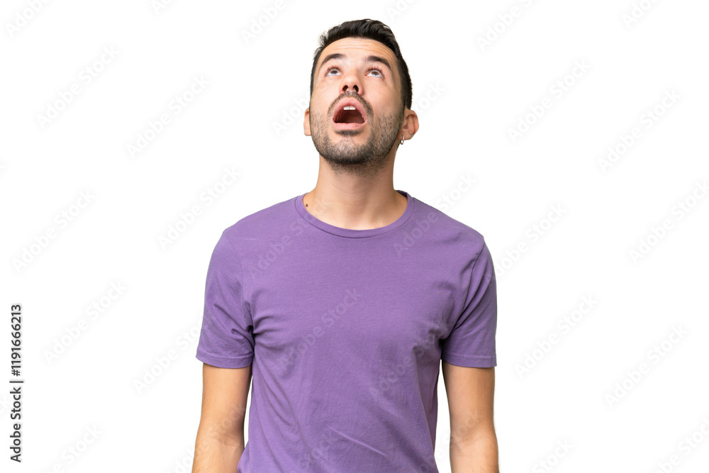 Young handsome caucasian man over isolated background looking up and with surprised expression Young handsome caucasian man over isolated background looking up and with surprised expression
